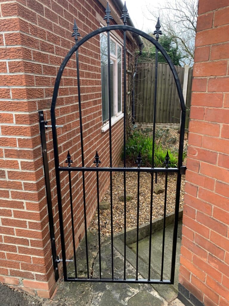 Bespoke wrought iron gate with curved top detail